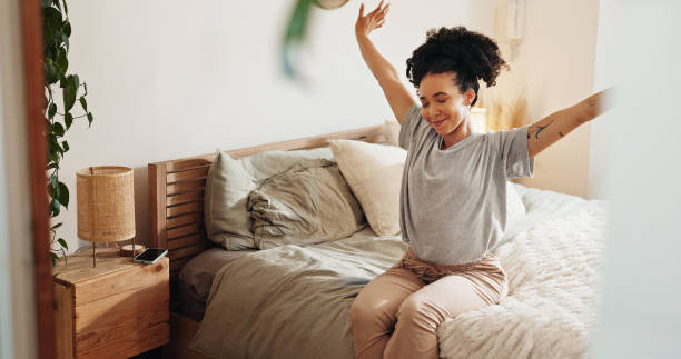 Woman stretching in bed, embracing morning wellness